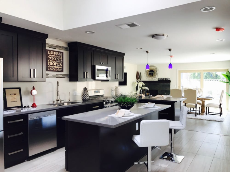 A kitchen with black cabinets