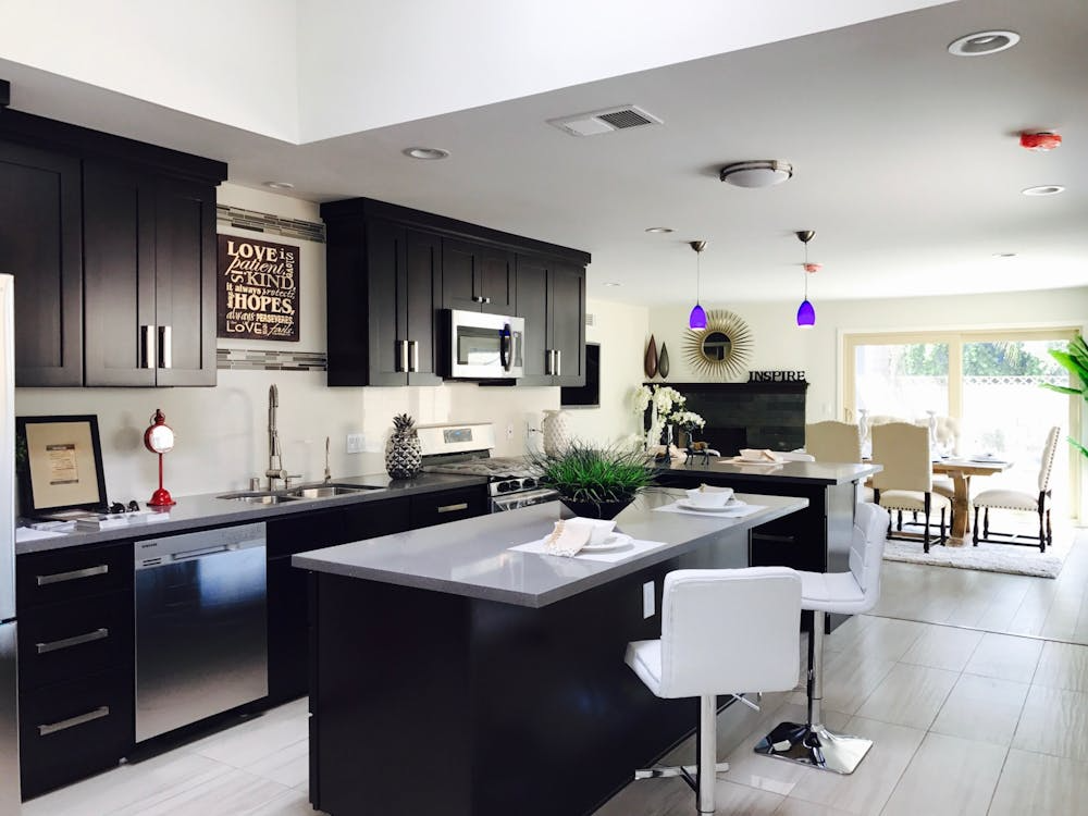 A kitchen with black cabinets