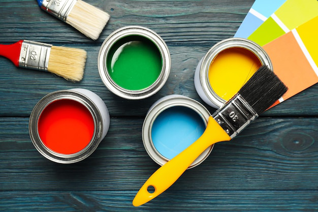 Buckets of paints and paint brushes
