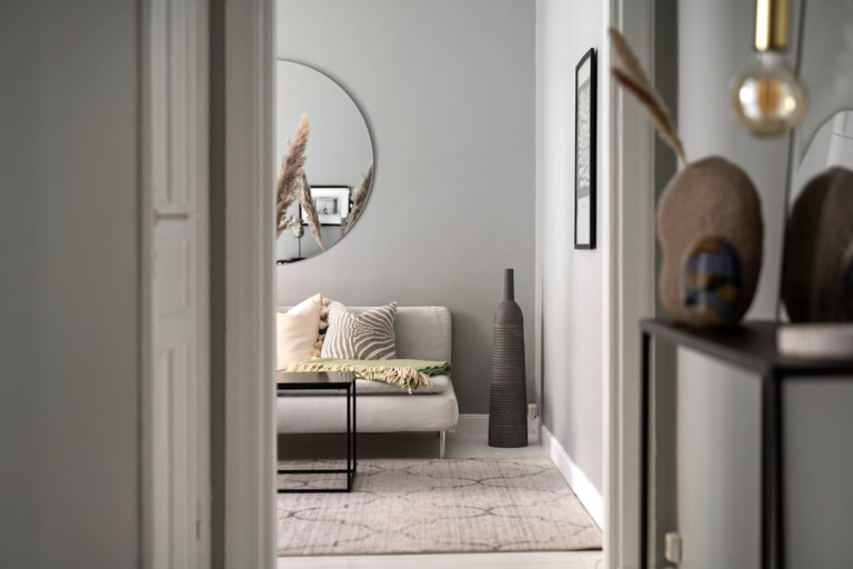 An image of a white wall decorated with mirrors