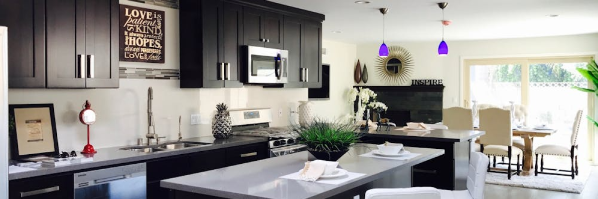 A kitchen with black cabinets
