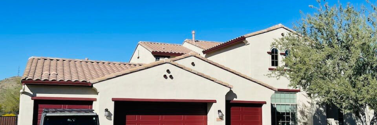 A newly painted dark-colored garage door with a jeep parked outside