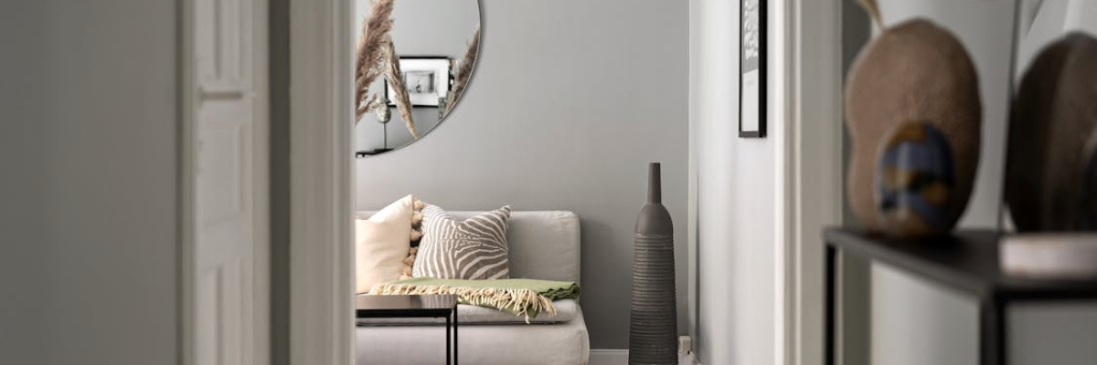 An image of a white wall decorated with mirrors