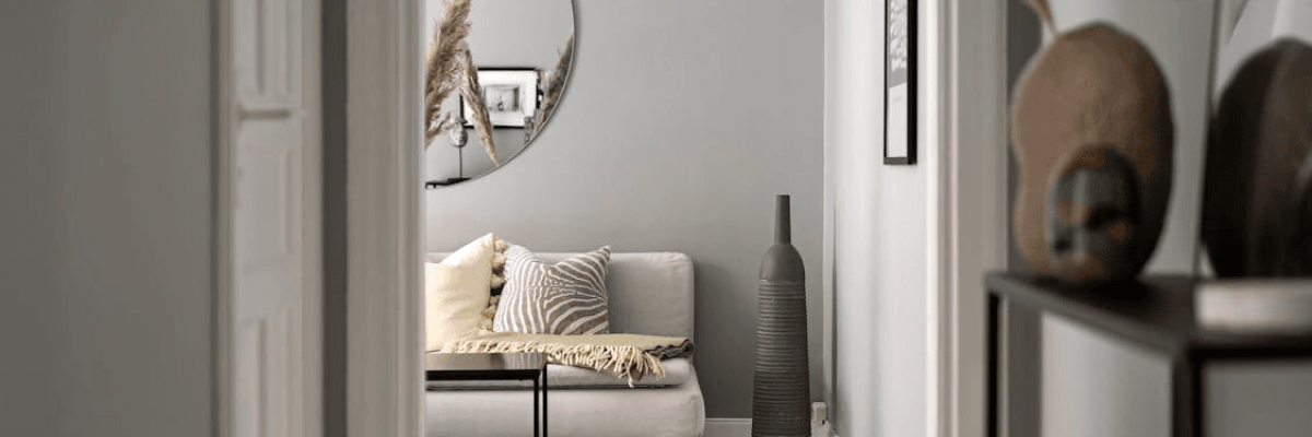 An image of a white wall decorated with mirrors