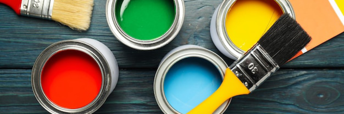 Buckets of paints and paint brushes